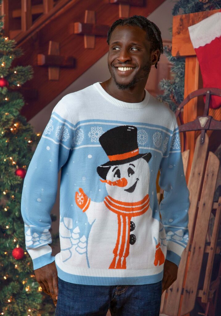 a man wearing an ugly Christmas sweater and a snowman waving