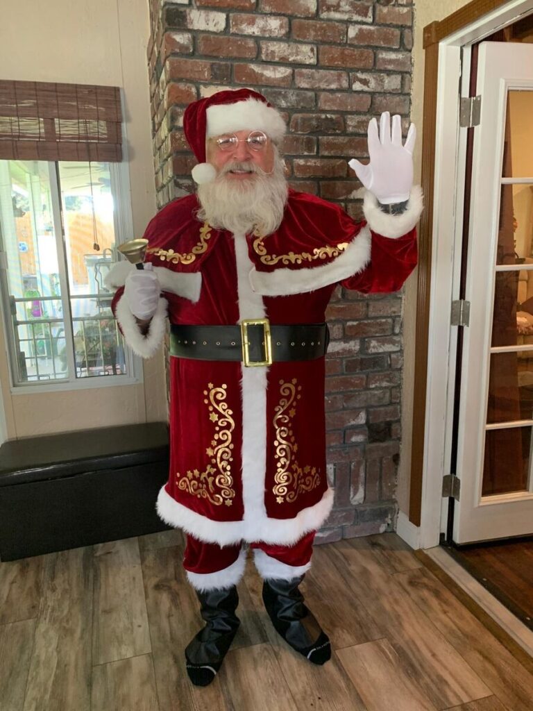 santa Claus waving and smiling at the camera