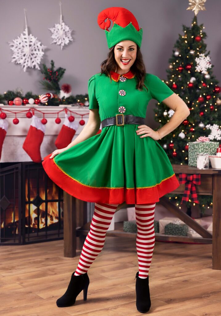 a woman wearing a green and red holiday elf costume